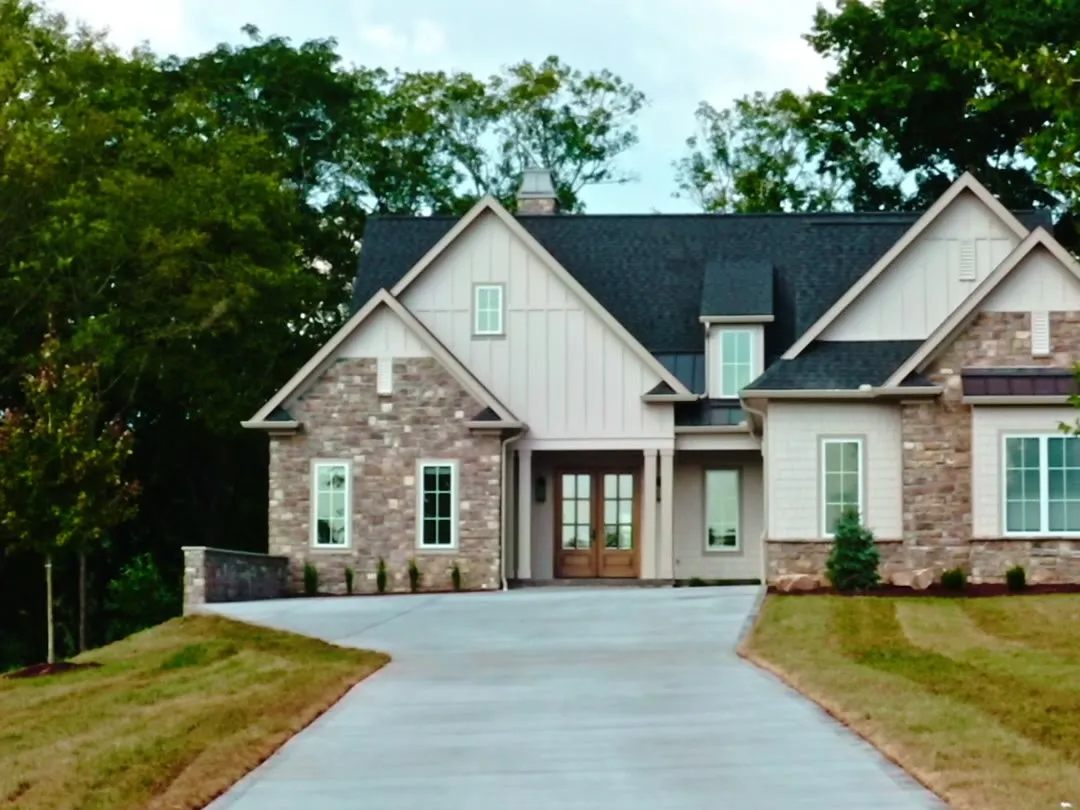The Craftsman Estate, a stone and board-and-batten home at the end of a long drive